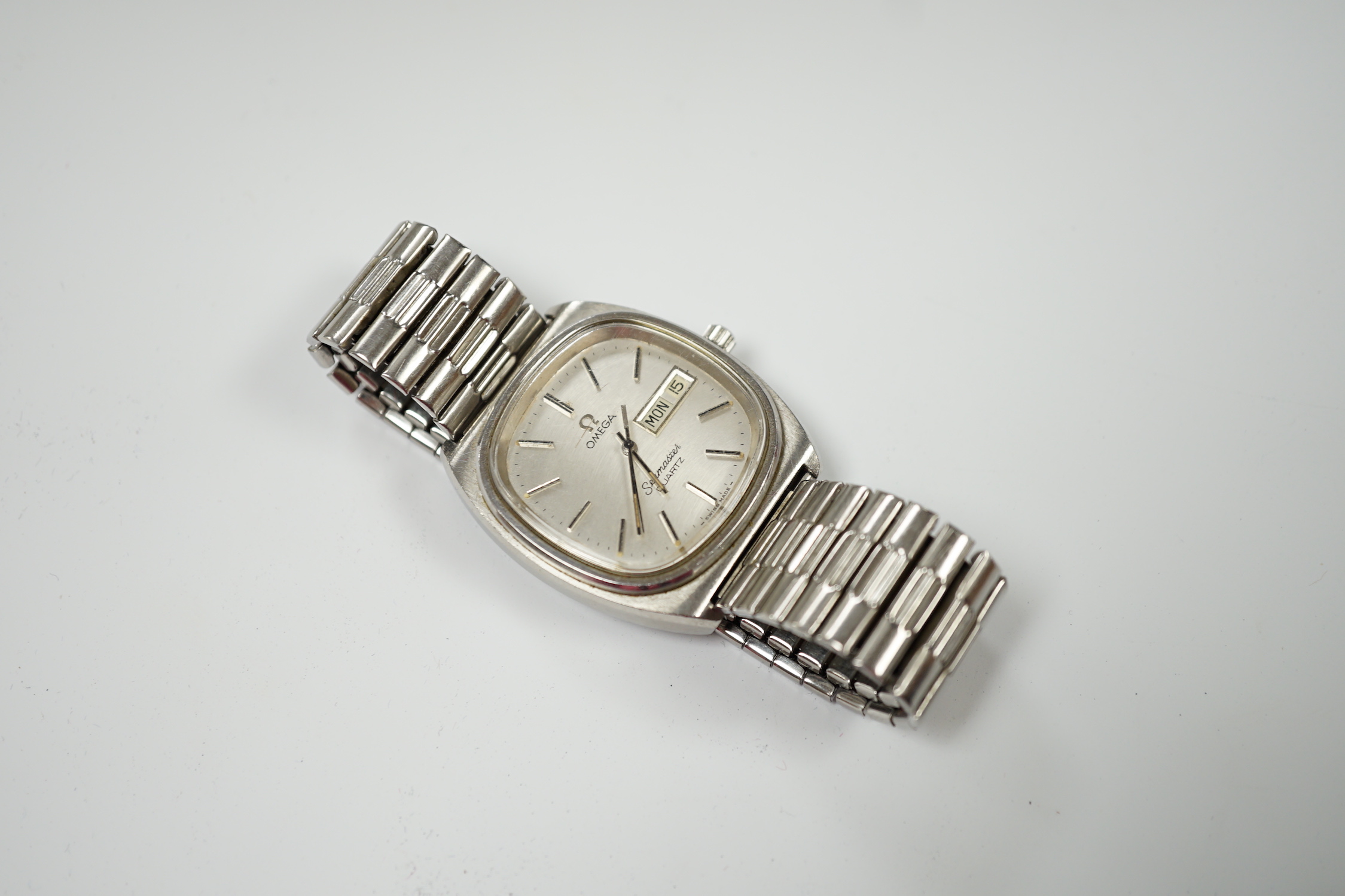 A gentleman's 1980's stainless steel Omega Seamaster quartz wrist watch, with day date aperture, on associated flexible strap, with box and papers.